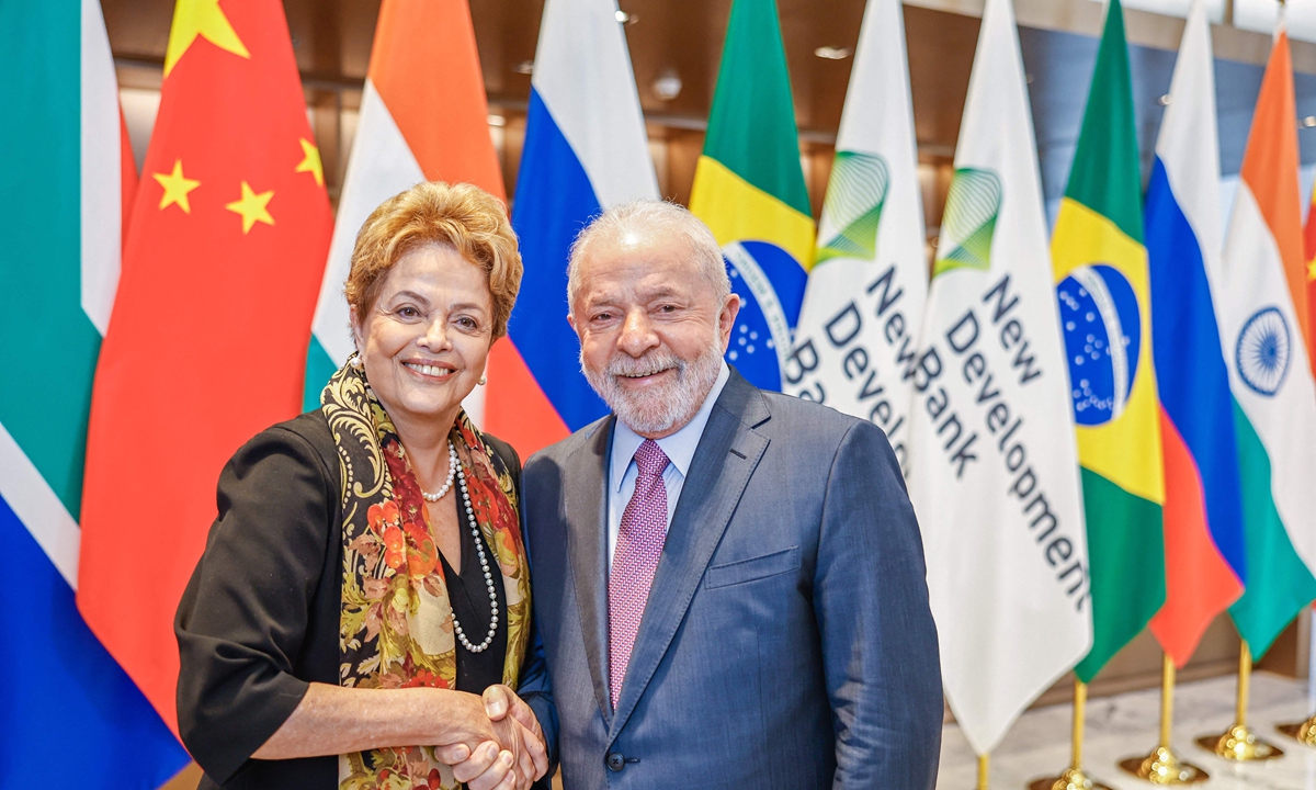 Brazilian President Luiz Inacio Lula da Silva (R) and Brazilian former President Dilma Rousseff shake hands after Rousseff took office as the new President of the New Development Bank (NDB) in Shanghai, China on April 13, 2023. Photo:AFP