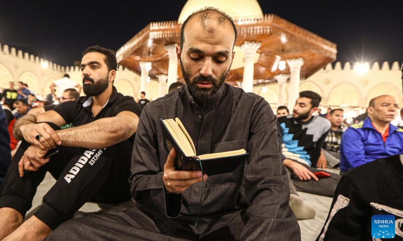 A Muslim reads a book as he attends the Laylat al-Qadr night prayers during Ramadan at Amr ibn Al-A'as Mosque in Cairo, Egypt, on April 17, 2023.(Photo: Xinhua)