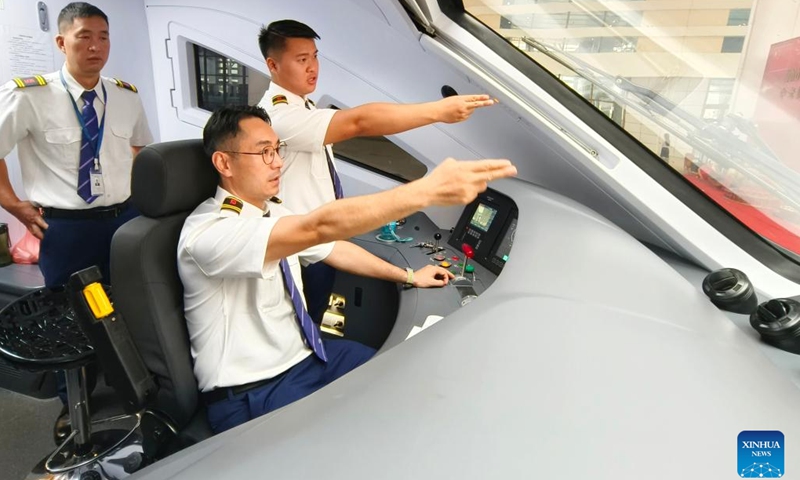 Lao and Chinese drivers of a cross-border passenger train bound for Kunming in southwest China's Yunnan Province prepare for departure from Vientiane, Laos on April 13, 2023. (Photo: Xinhua)