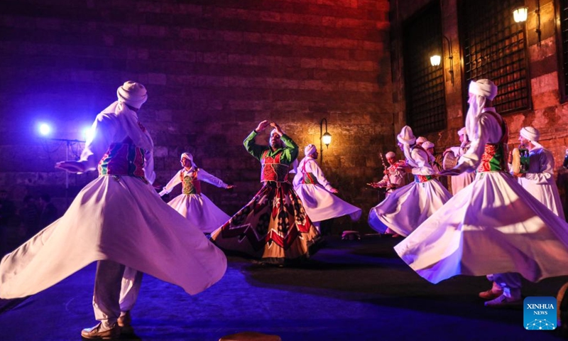 Dancers perform Tanoura, a traditional Egyptian folk dance, during the holy month of Ramadan at the Sultan Al-Ghuri complex in Cairo, Egypt, on April 12, 2023. Tanoura is an Arabic word, which means skirt in English. Tanoura dance is a traditional folk dance in Egypt, where the dancer in colorful skirts spins to the tunes of songs.(Photo: Xinhua)