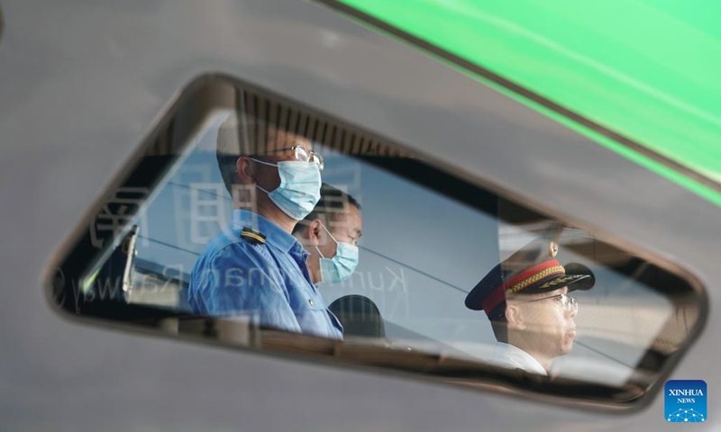 Crew members of a passenger train bound for the Lao capital Vientiane prepare for departure from Kunming South Railway Station in Kunming, southwest China's Yunnan Province, April 13, 2023.(Photo: Xinhua)