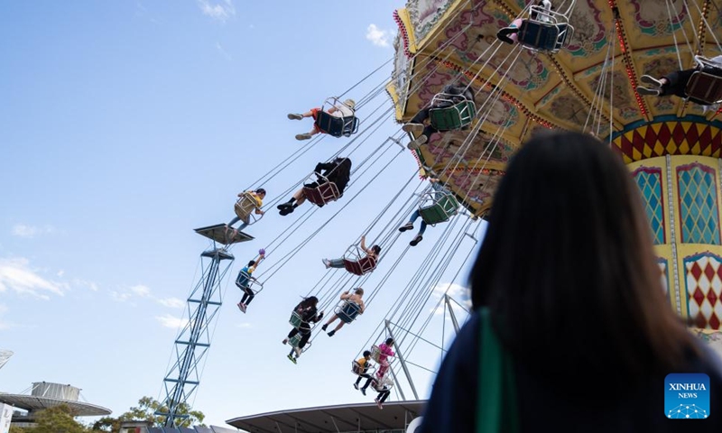 Visitors enjoy a swing ride at the Sydney Royal Easter Show in Sydney, Australia, on April 12, 2023. While Easter is often associated with hopping bunnies and chocolate eggs, an annual gala held in Sydney has added an Aussie twist to the annual holiday, combining rural traditions with modern-day entertainment.(Photo: Xinhua)