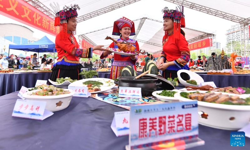 Candidates present their creations for a contest of specialty dishes at a cultural square in Dahua Yao Autonomous County, south China's Guangxi Zhuang Autonomous Region, April 15, 2023. A gourmet competition was held here on Saturday to mark the traditional Sanyuesan festival, which falls on the third day of the third month on the lunar calendar. Hundreds of dishes made with indigenous produces participated in the competition. (Xinhua/Huang Xiaobang)