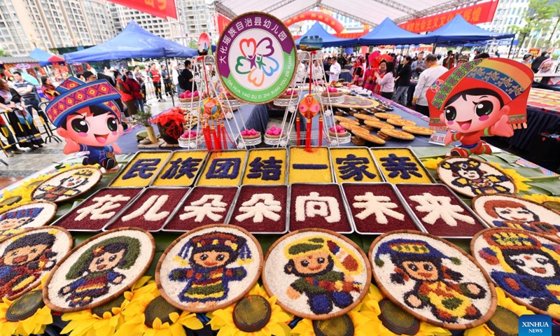 Candidate creations for a contest of colorful meals made with glutinous rice are pictured at a cultural square in Dahua Yao Autonomous County, south China's Guangxi Zhuang Autonomous Region, April 15, 2023. A gourmet competition was held here on Saturday to mark the traditional Sanyuesan festival, which falls on the third day of the third month on the lunar calendar. Hundreds of dishes made with indigenous produces participated in the competition. (Xinhua/Huang Xiaobang)