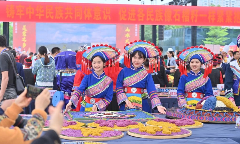 Candidates present their creations for a contest of colorful meals made with glutinous rice at a cultural square in Dahua Yao Autonomous County, south China's Guangxi Zhuang Autonomous Region, April 15, 2023. A gourmet competition was held here on Saturday to mark the traditional Sanyuesan festival, which falls on the third day of the third month on the lunar calendar. Hundreds of dishes made with indigenous produces participated in the competition. (Xinhua/Huang Xiaobang)