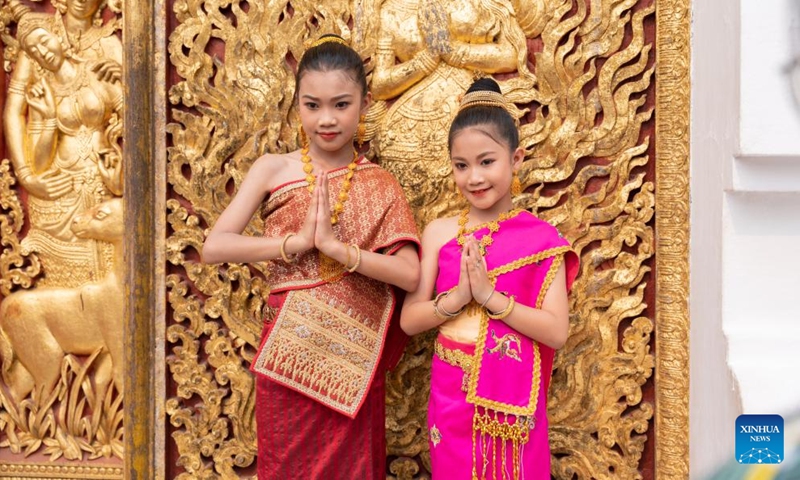 Girls pose for photos during the celebration of the Songkran Festival or the Lao New Year, in Luang Prabang, Laos, April 15, 2023. The Lao New Year, celebrated from April 14 to 16, is the most important festival in the Lao calendar and also a time of endless fun for the Laotians. (Photo by Kaikeo Saiyasane/Xinhua)