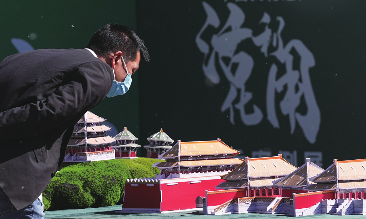 Visitors view a model of the Beijing Central Axis complex on display in Beijing on April 18, 2023, which marks the International Day for Monuments and Sites. China held an event to celebrate the day at the Old Summer Palace, or Yuanmingyuan in Chinese, in Beijing. Photo: VCG