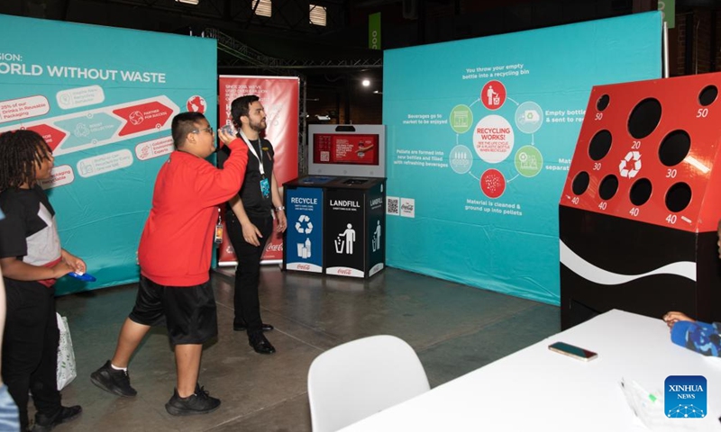 A boy plays a game related to recycling at the Earthx2023 in Dallas, Texas, the United States, on April 21, 2023. The Earthx2023, an Earth Day event, kicked off here on Friday, highlighting a wide range of environmental and sustainability-related topics.(Photo: Xinhua)