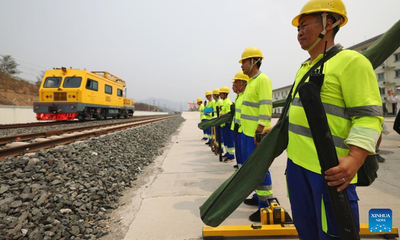 Railway staff members participate in a maintenance drill of the overhead contact system near the Luang Prabang station of the China-Laos Railway in Luang Prabang, Laos, on April 17, 2023.(Photo: Xinhua)