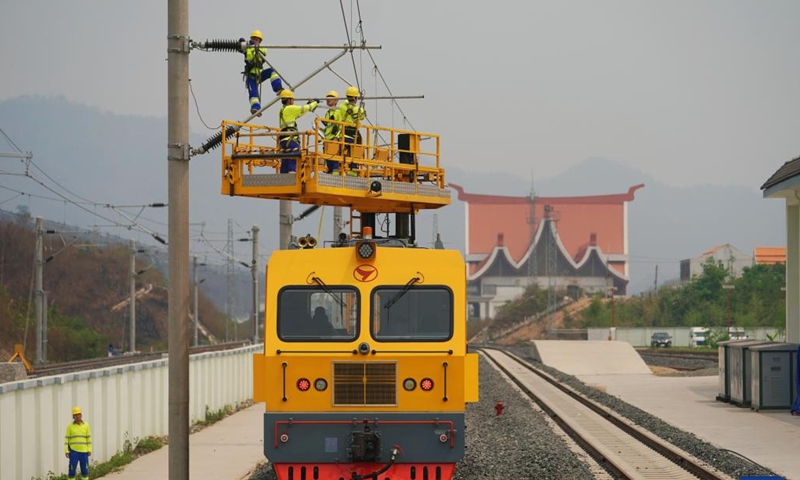 Railway staff members participate in a maintenance drill of the overhead contact system near the Luang Prabang station of the China-Laos Railway in Luang Prabang, Laos, on April 17, 2023.(Photo: Xinhua)