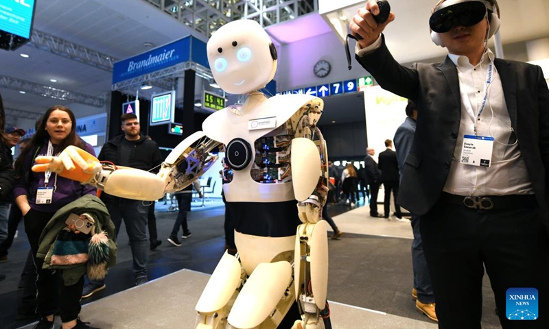An intelligent robot imitates the gesture of a man during the Hannover Messe in Hannover, Germany, on April 18, 2023. Germany's leading trade fair for mechanical and electrical engineering kicked off on Monday in Hannover, with the theme of Industrial Transformation - Making the Difference.(Photo: Xinhua)