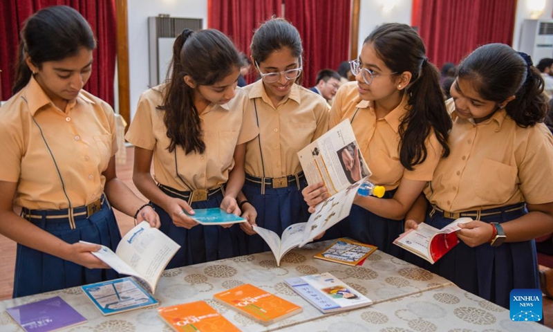 Indian students read Chinese books while attending a dialogue with Chinese taikonauts on board the orbiting Chinese Tiangong space station in New Delhi, India, April 20, 2023. Over 50 Indian youth on Thursday attended a dialogue with Chinese taikonauts on board the orbiting Chinese Tiangong space station.(Photo: Xinhua)