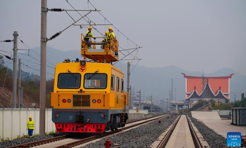 Railway staff members participate in a maintenance drill of the overhead contact system near the Luang Prabang station of the China-Laos Railway in Luang Prabang, Laos, on April 17, 2023.(Photo: Xinhua)