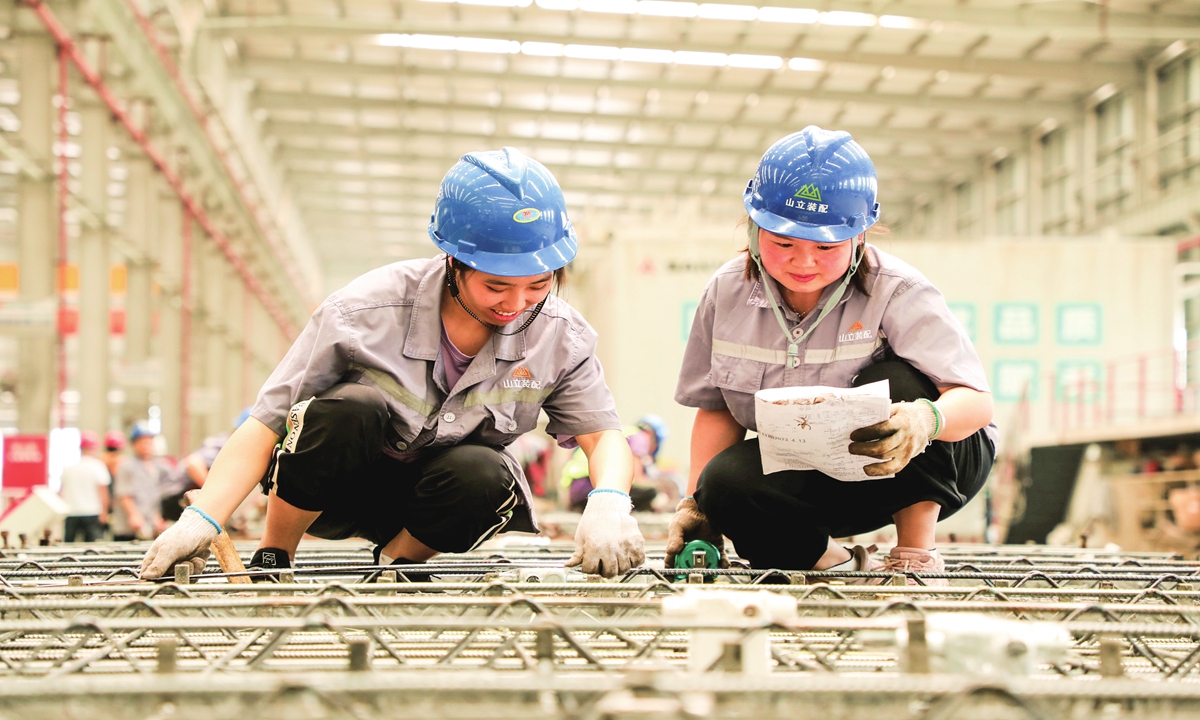 Workers produce building materials at a factory on April 19, 2023 in Meishan, Southwest China's Sichuan Province. The company has been promoting the application of intelligent construction platforms to increase digitalization and intelligence and the green level of production. Photo: VCG