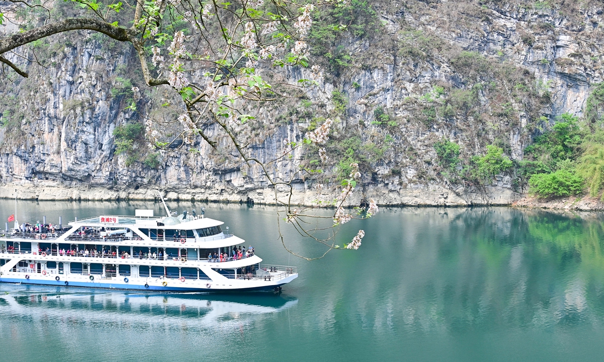 A boat filled with tourists navigates the waters of an ancient town in Youyang, Southwest China's Chongqing Municipality on April 20, 2023. In the first quarter of 2023, the total number of ticketed tourists in Youyang scenic spots reached 1.26 million, up 40 percent compared with the same period in 2019. Photo: IC