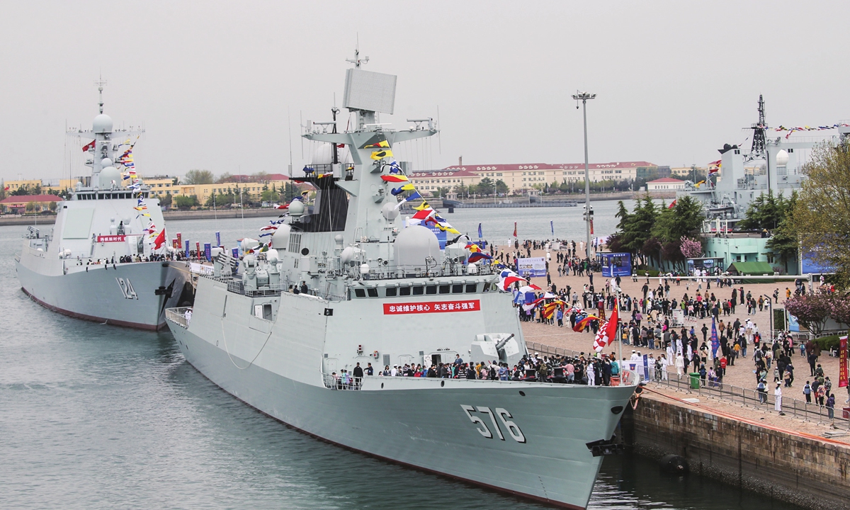 Tourists visit the Type 052D destroyer <em>Kaifeng</em> and guided-missile frigate <em>Daqing</em> of the PLA Navy during a warship open day event in Qingdao, East China's Shandong Province on April 22, 2023. The open day was held as part of naval events marking the 74th founding anniversary of the PLA Navy on April 23. Photo: Sun Fei