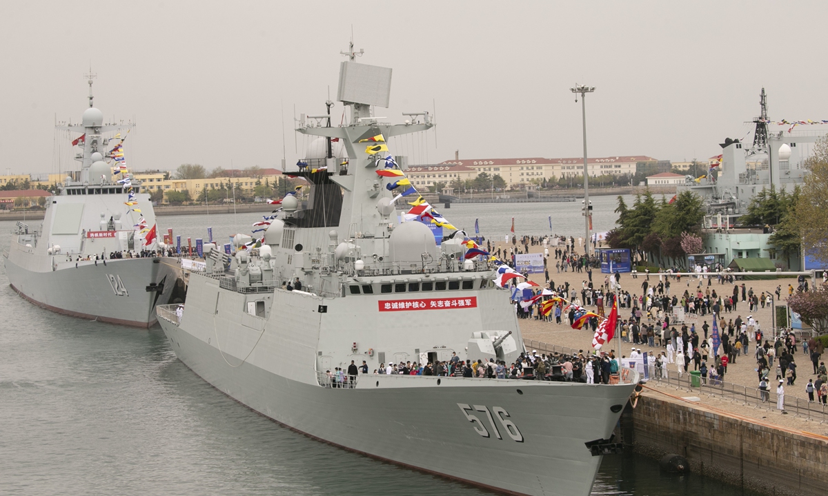 People visit the Type 054A frigate Daqing, hull number 576, and the Type 052D destroyer Kaifeng, hull number 124, of the People's Liberation Army (PLA) Navy at a wharf in Qingdao Port, East China's Shandong Province, on April 22, 2023. From April 22 to 24, the PLA Navy is holding barracks-open events in 22 cities and displaying warships in active service to the public as the force celebrates 74th anniversary of its establishment that falls on April 23. Photo: Xinhua
