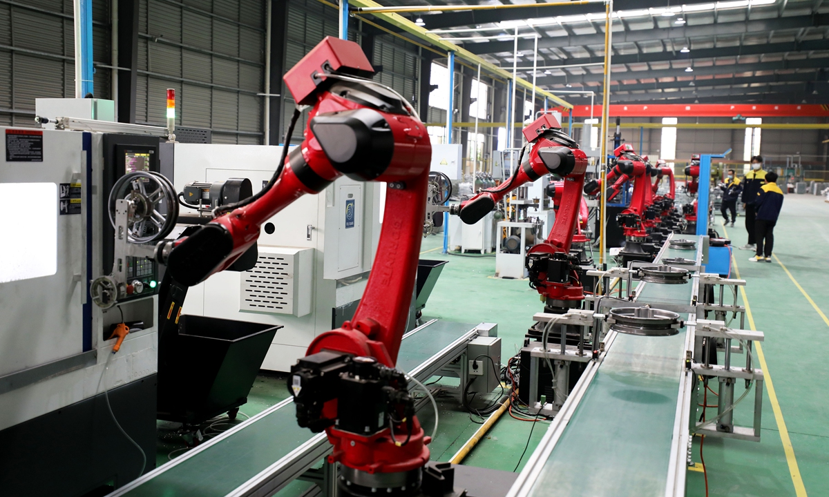 Robotic arms install vehicle and motorcycle wheel parts at an automotive parts assembly factory in a local industrial park in Huaibei city, East China's Anhui Province, on April 22, 2023. China's auto manufacturing and sales are gaining pace this year. 
Photo: VCG