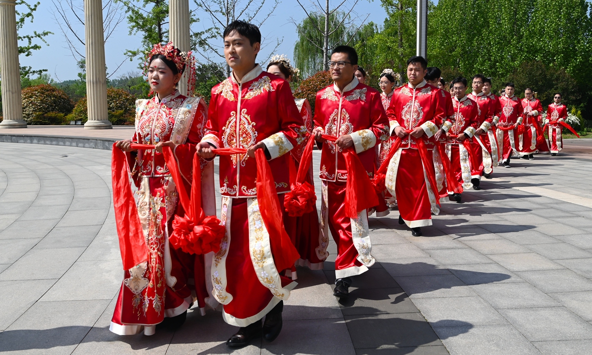 The city of Liaocheng, East China's Shandong Province holds its first group marriage ceremony on April 25, 2023, attended by 10 newlywed couples, as the country launches a?campaign against problems including exorbitant bride prices and extravagant wedding ceremonies. Photo: IC