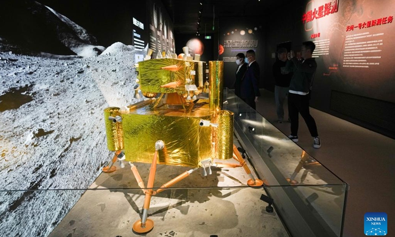 A visitor views a model of the Chang'e-5 lunar probe at the China Space Museum in Beijing, capital of China, April 24, 2023. After its renovation, the China Space Museum reopened to the public on the occasion of the Space Day of China on Monday. The museum features exhibition sections covering such themes as carrier rockets, satellites and manned spaceships, exposing visitors to the development of China's aerospace industry.(Photo: Xinhua)