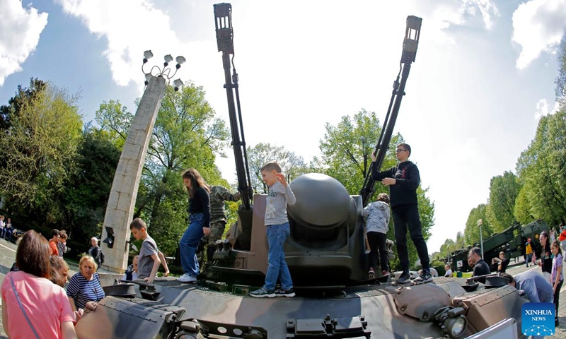 Children have fun on an armoured vehicle at a static exhibition of military equipment marking Romanian Land Forces Day at a park in Bucharest, capital of Romania, April 23, 2023.(Photo: Xinhua)