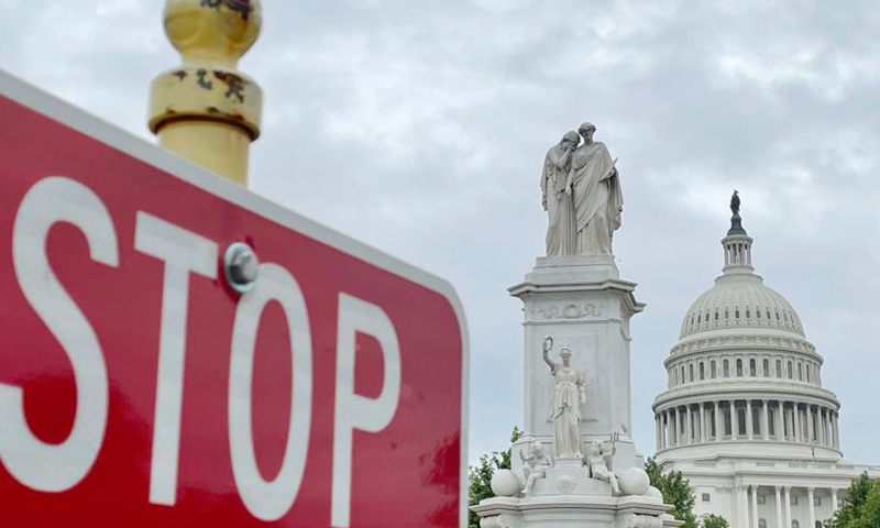 The U.S. Capitol building sits in the background of a traffic sign in Washington, D.C., the U.S., May 28, 2021.(Photo: Xinhua)