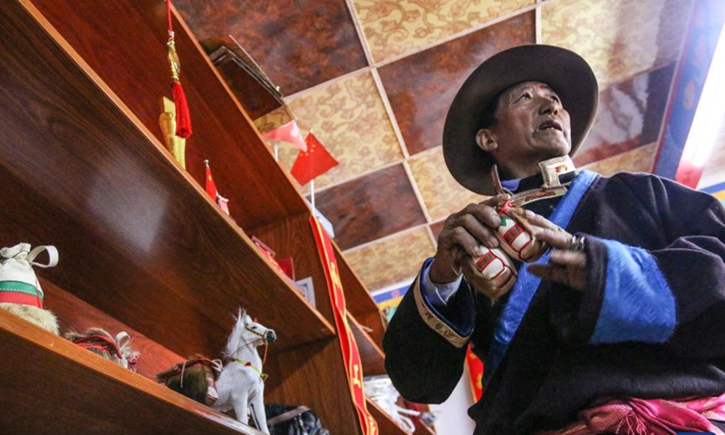 Sonam Qoipei displays a handiwork of horse bag in Nang County of Nyingchi, southwest China's Tibet Autonomous Region, April 18, 2023.(Xinhua/Nie Yi)