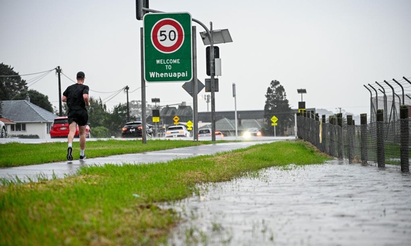 A man runs on a road in Auckland, New Zealand, May 9, 2023. New Zealand's Auckland declared local state of emergency following floods and torrential downpours on Tuesday.(Photo: Xinhua)