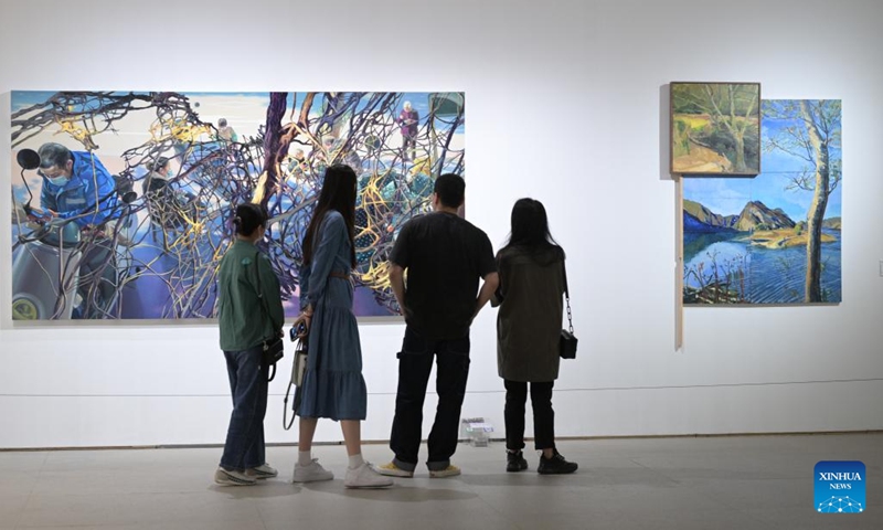 Visitors view oil paintings at 2023 China Central Academy of Fine Arts (CAFA) postgraduate works exhibition in Beijing, capital of China, May 9, 2023. Over 3,000 pieces of postgraduate works were displayed in the exhibition, including paintings, sculptures, digital art, etc(Photo: Xinhua)