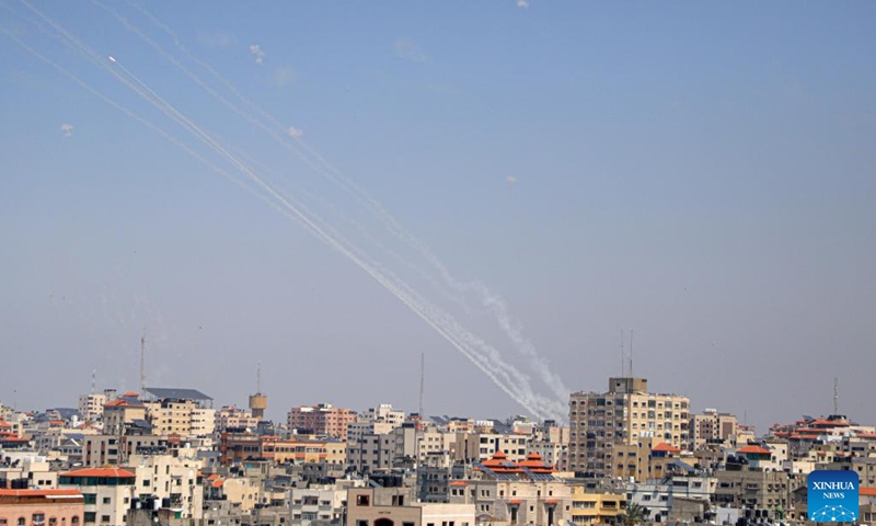 A barrage of rockets fired from Gaza into Israel are seen in the sky over Gaza City, on May 10, 2023. The Gaza-based joint chamber of military operations of Palestinian factions claimed firing a barrage of rockets to southern and central Israel on Wednesday, in response to the surprising Israeli airstrikes on Tuesday predawn, which killed three senior members of the Palestinian Islamic Jihad (PIJ) movement's armed wing in the Gaza Strip and their wives and children.(Photo: Xinhua)