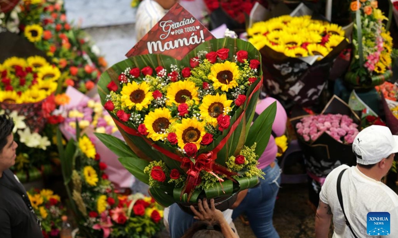 A flower seller shows flowers prepared for Mother's Day in Mexico City, Mexico, May 9, 2023. Mother's Day in Mexico is celebrated on May 10. (Photo: Xinhua)