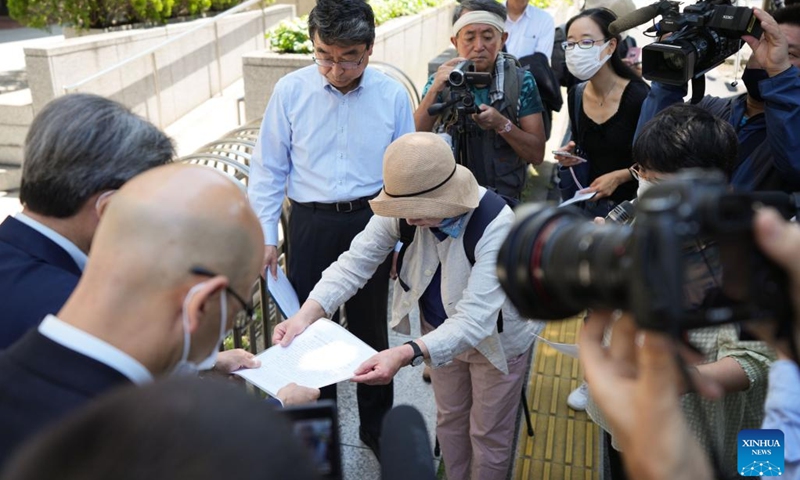 Chiyo Oda (C), co-director of KOREUMI, a Japanese citizens' conference to condemn further pollution of the ocean, submits a petition to a representative of Tokyo Electric Power Company (TEPCO) in front of TEPCO headquarters in Tokyo, Japan, May 16, 2023. Hundreds of Japanese people on Tuesday gathered at multiple locations in Tokyo to protest against the government's plan to discharge nuclear-contaminated water from the crippled Fukushima Daiichi Nuclear Power Plant into the sea, demanding immediate suspension of such plan(Photo: Xinhua)