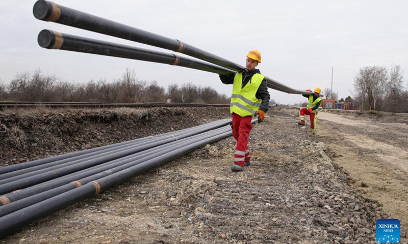 Workers carry electrical conduits at a construction site of Hungary-Serbia railway project in Szabadszallas, Hungary, Feb. 22, 2023. At the offices, construction sites, or even out in the fields, experts, workers from different parts of the world joined together for their common goal that is to build and upgrade the railway linking Budapest in Hungary to Belgrade in Serbia, a major project under the Belt and Road Initiative (BRI), symbolizing deep cooperation between China and Europe.(Photo: Xinhua)