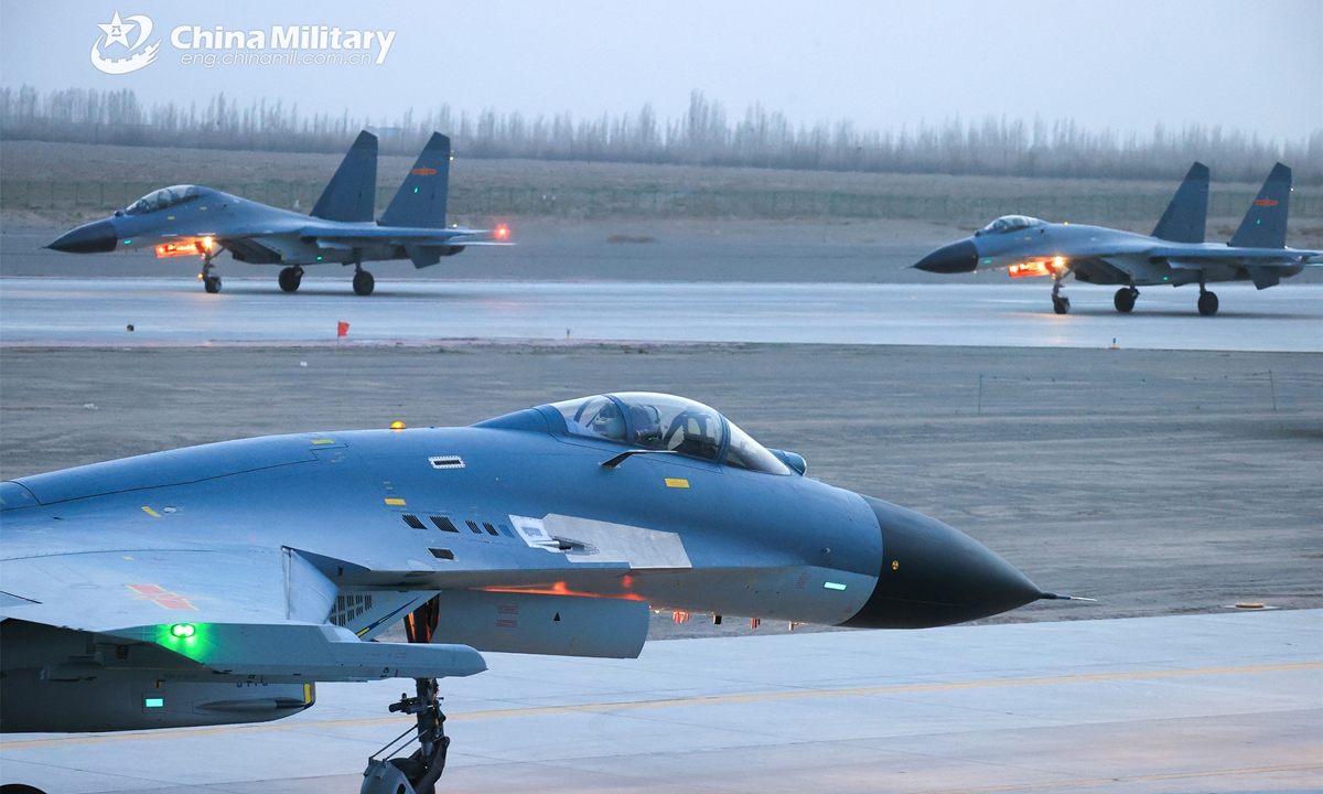 Fighter jets attached to an aviation brigade of the air force taxi on the runway during a round-the-clock flight training exercise in early May, 2023. (eng.chinamil.com.cn/Photo by Cui Baoliang)