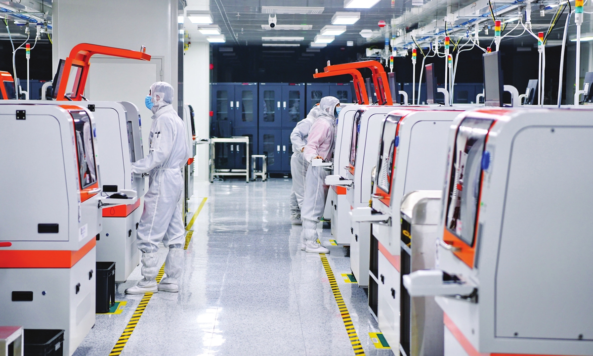 Workers process and produce chips for foreign trade export in a technology company in Ganzhou, East China's Jiangxi Province on March 28, 2022. Photo: VCG