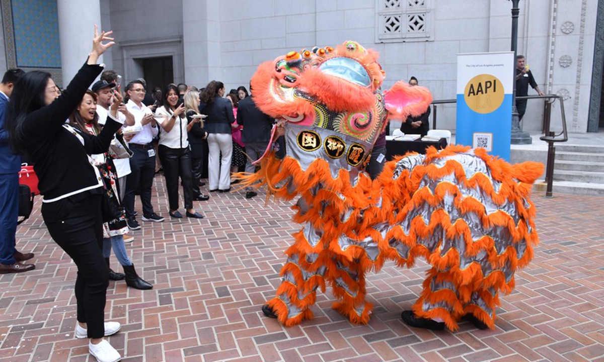People perform lion dance at the opening ceremony of the Asian American and Pacific Islander Heritage Month held in the Spring Court of Los Angeles City Hall in Los Angeles, the United States, on May 12, 2023. (Photo by Zeng Hui/Xinhua)

