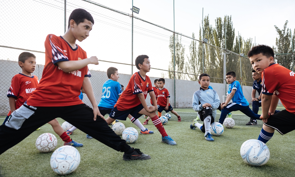 Kashi Prefecture's Pamir Soccer Club's cadets warm up before practice on May 11, 2023.