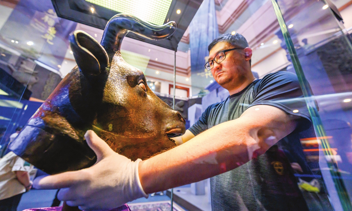 A worker at the Dongguan Museum unpacks 86 repatriated cultural relics including Old Summer Palace bronze heads on May 16, 2023 in Dongguan, Guangdong Province. 