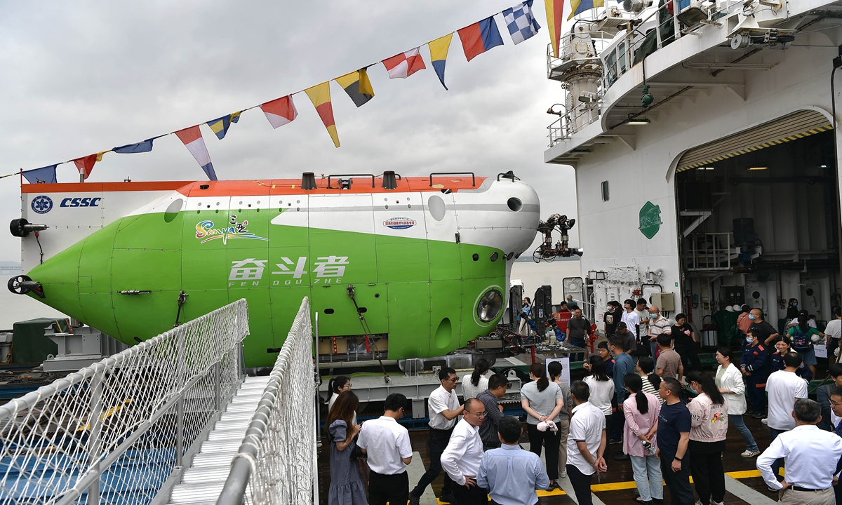 Visitors look at the Fendouzhe submersible aboard the Tan Suo Er Hao research vessel, which docked at a pier in Fuzhou, East China's Fujian Province on May 17, 2023. The Fendouzhe is China's first manned diving device with the ability to enter global waters, and the first manned submersible with independent intellectual property rights. Photo: cnsphoto  