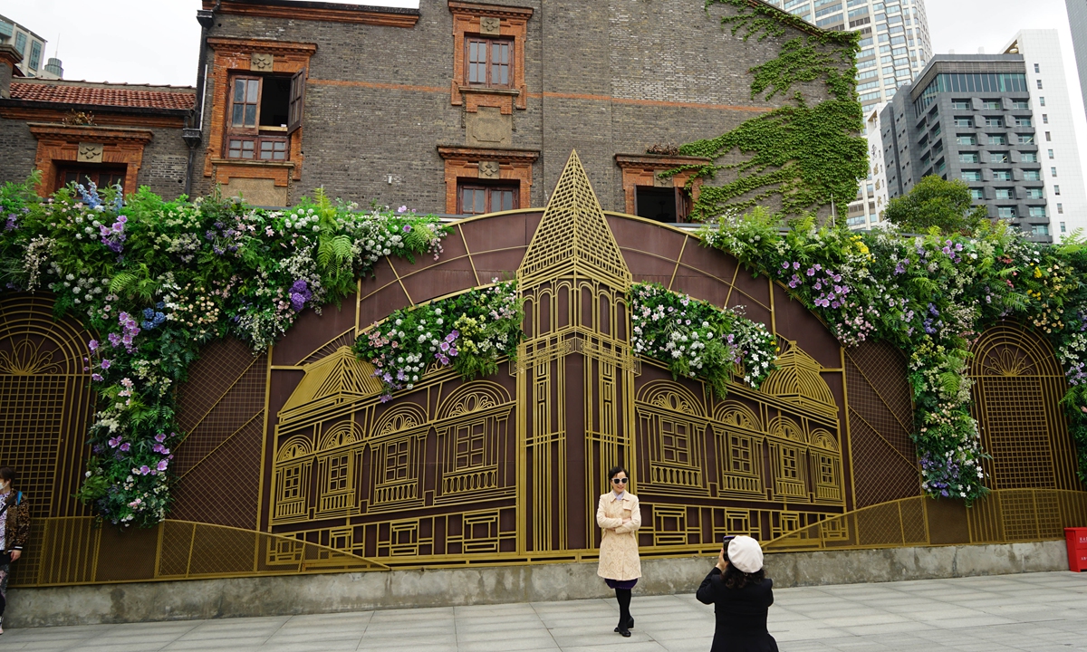 A visitor poses for a photo at the newly restored Zhang Yuan in central Shanghai. Photo: Lu Ting/GT