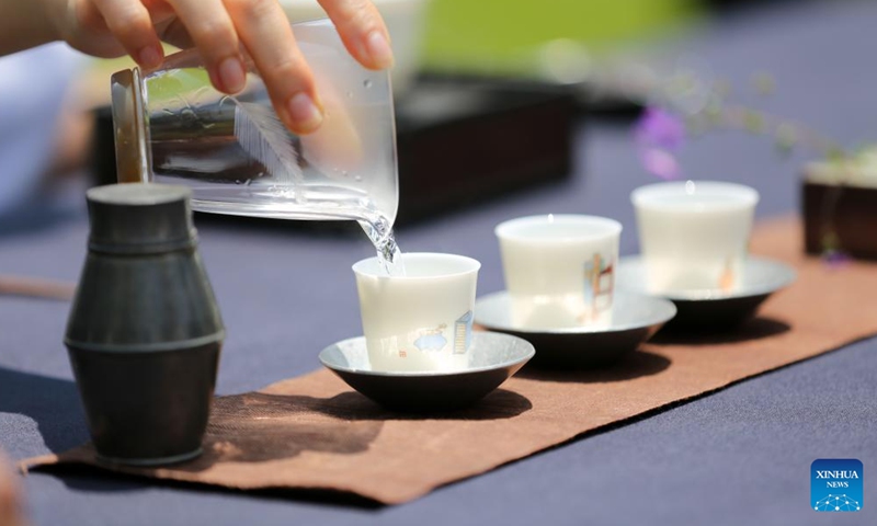 A tea art specialist performs in Seoul, South Korea, May 19, 2023. A series of events to promote Chinese tea culture was launched by the Chinese Cultural Center here on Friday to mark the upcoming International Tea Day. (Xinhua/Wang Yiliang)