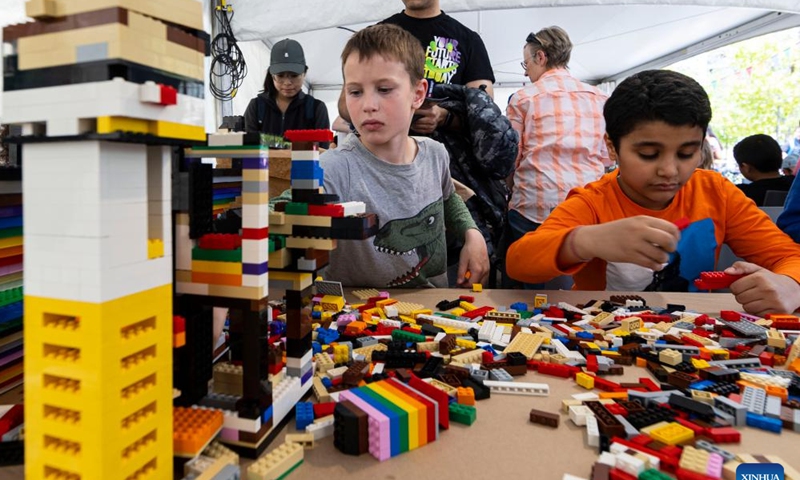 Children play with Lego bricks during the 2023 Junior International Children's Festival in Toronto, Canada, May 21, 2023. The event is held here from May 20 to 22 to inspire children to recognize their limitless potential and learn about the world around them. (Photo by Zou Zheng/Xinhua)