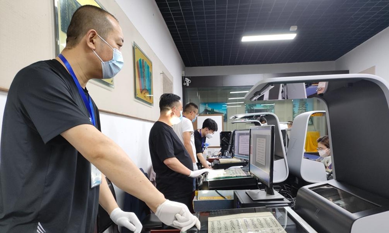 This undated photo provided by the cultural relics institute of Zhangye Giant Buddha Temple shows technicians digitalizing items preserved in the Giant Buddha Temple in Zhangye City, northwest China's Gansu Province. (The cultural relics institute of Zhangye Giant Buddha Temple/Handout via Xinhua)