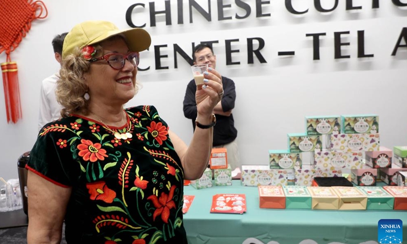 A visitor prepares to taste tea during the Tea for Harmony cultural salon at the China Cultural Center in Tel Aviv, Israel, on May 21, 2023. A cultural salon named Tea for Harmony was held here on Sunday. Several booths were set up for participants to taste different kinds of Chinese tea, in addition to dances and Wushu demonstrations with performers from central China's Henan Province. (Photo by Gil Cohen Magen/Xinhua)