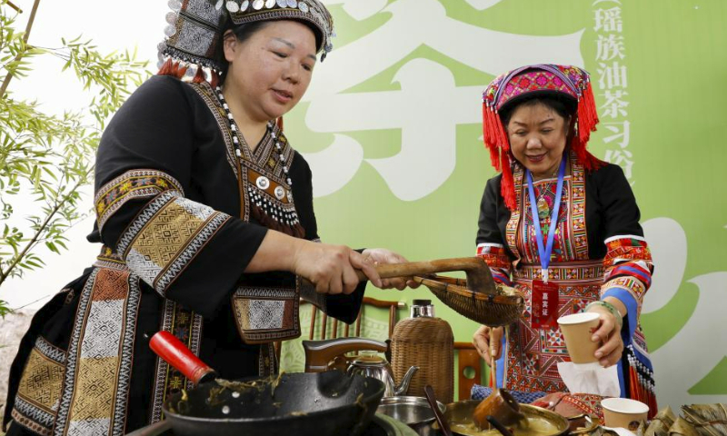 Staff display oil tea custom of Yao people during a tea culture event held in Fuzhou, southeast China's Fujian Province, May 21, 2023. May 21 marks the International Tea Day. (Xinhua/Jiang Kehong)