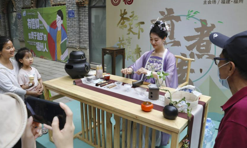 A staff member shows traditional tea art during a tea culture event held in Fuzhou, southeast China's Fujian Province, May 21, 2023. May 21 marks the International Tea Day. (Xinhua/Jiang Kehong)
