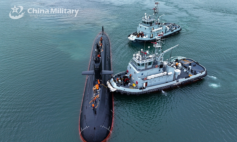 Two towboats attached to a naval submarine flotilla under the PLA Northern Theater Command are about to tow a submarine to bear off a port during a training exercise on May 6, 2023. (eng.chinamil.com.cn/Photo by Shi Jialong)