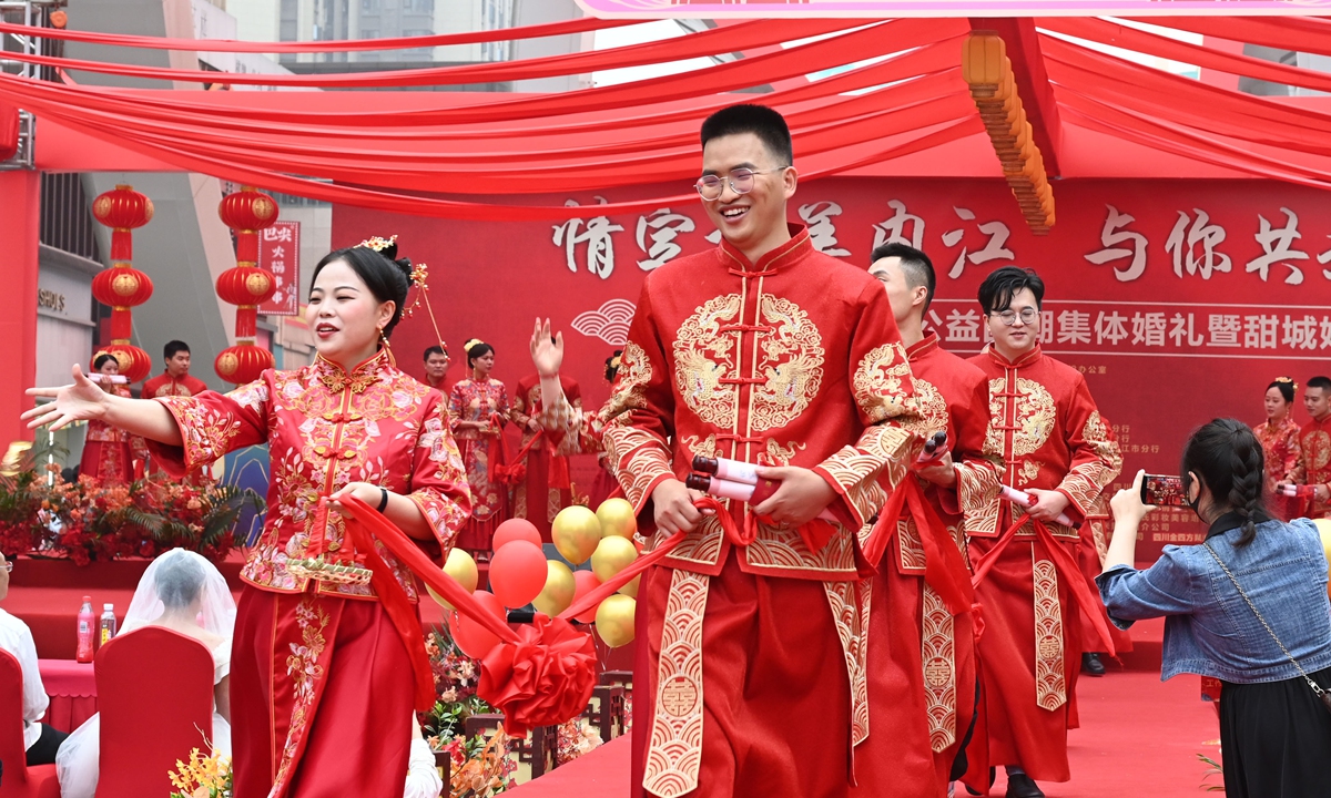 Couples participate in a group wedding ceremony held in Neijiang, Southwest China's Sichuan Province, on May 20, 2023, which marked the unofficial Valentine's day in China as the number 