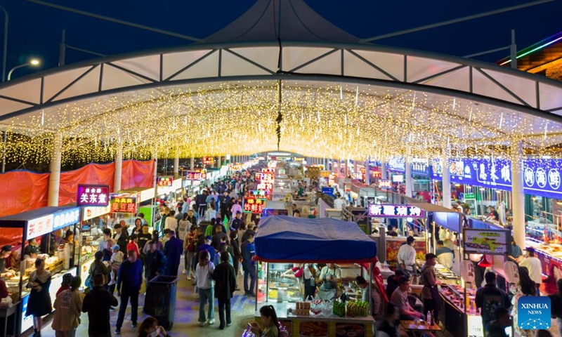 This aerial photo taken on May 19, 2023 shows a night market in Yichun, northeast China's Heilongjiang Province. The night market in Yichun has attracted a lot of tourists, which boosts its nighttime economy. (Xinhua/Zhang Tao)