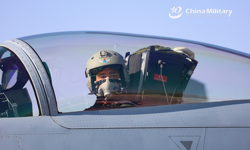 A pilot assigned to an aviation brigade with the air force under the PLA Western Theater Command gets ready to take off before a flight training exercise in late April, 2023.(eng.chinamil.com.cn/Photo by Yu Zeqi)